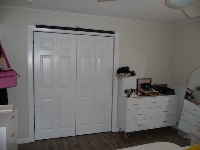 bedroom with dark hardwood / wood-style flooring, a closet, and ornamental molding