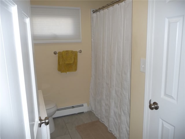 bathroom with a shower with curtain, toilet, and baseboard heating