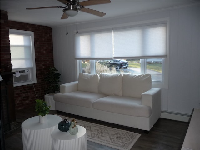 living room with dark hardwood / wood-style floors, a wealth of natural light, and a baseboard heating unit