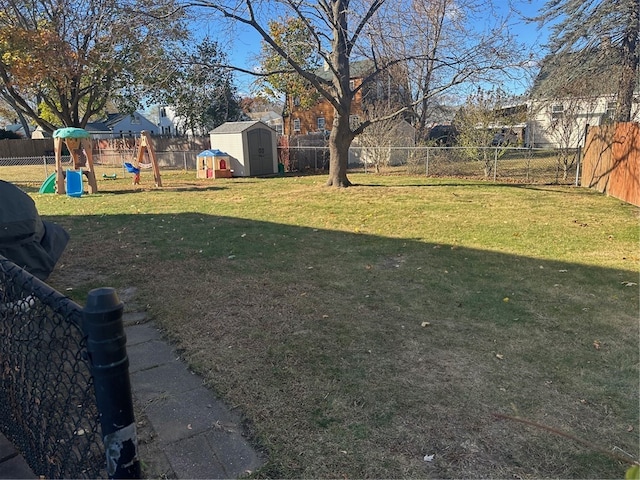 view of yard with a shed and a playground