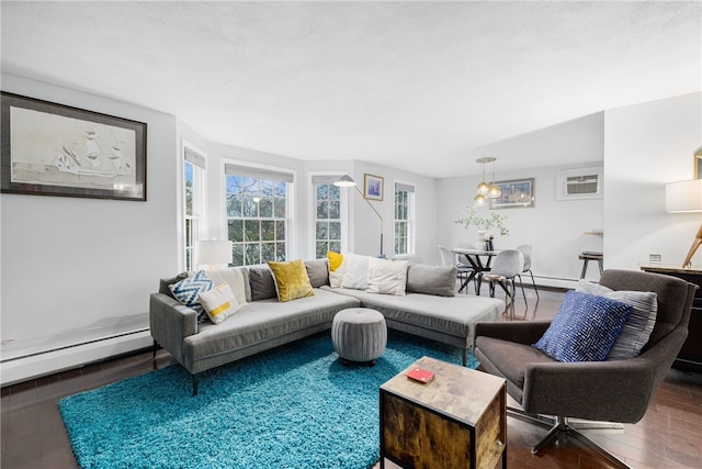 living room featuring a wall unit AC, hardwood / wood-style floors, and a baseboard heating unit