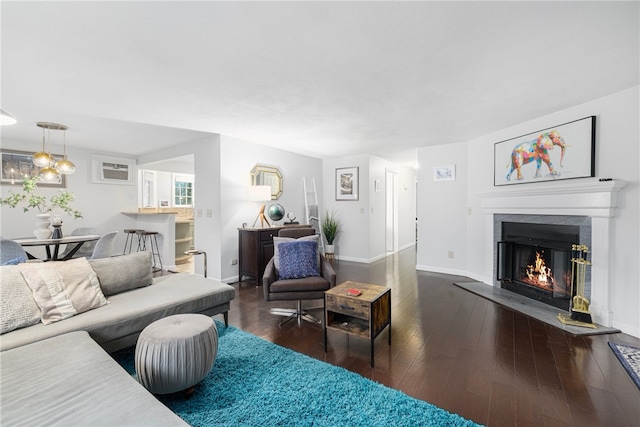 living room featuring dark hardwood / wood-style flooring and a wall unit AC