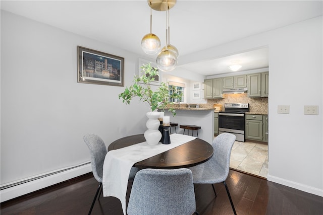 dining area with light hardwood / wood-style floors and a baseboard heating unit