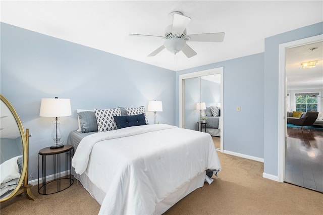 carpeted bedroom with ceiling fan and a closet