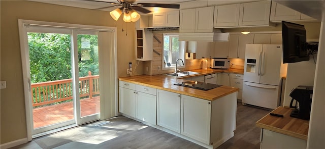 kitchen featuring wood counters, light wood-type flooring, white appliances, sink, and white cabinetry