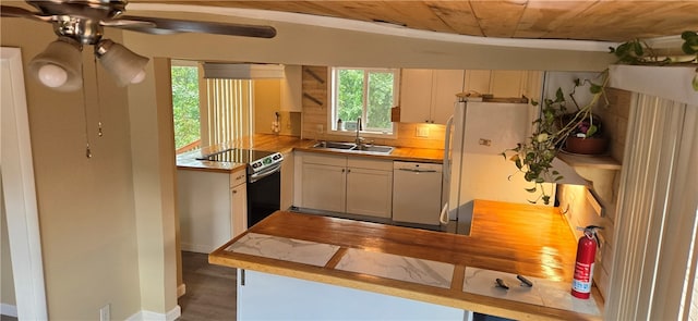 kitchen with wood ceiling, white appliances, kitchen peninsula, and a wealth of natural light