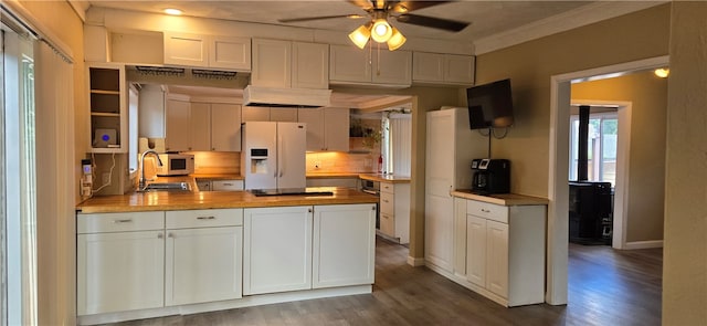 kitchen with ceiling fan, white fridge with ice dispenser, wood counters, dark hardwood / wood-style floors, and white cabinets