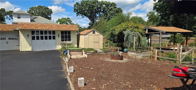 view of front of property featuring a garage and a storage unit