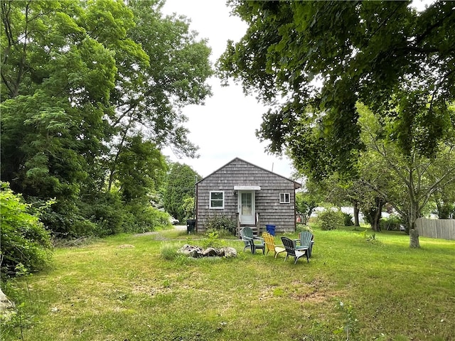 rear view of property with a lawn