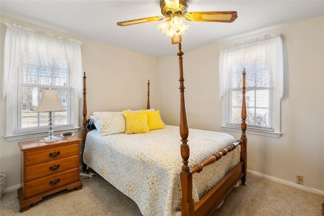 carpeted bedroom with multiple windows and ceiling fan