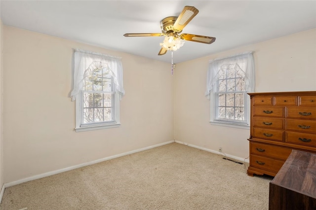 carpeted spare room with ceiling fan