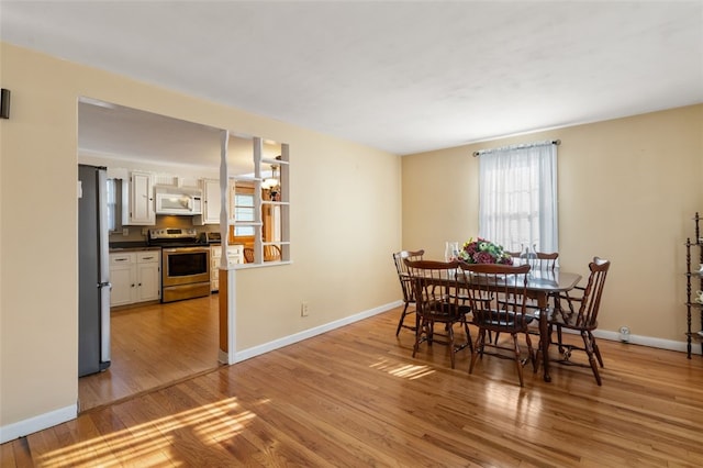 dining space featuring light wood-type flooring