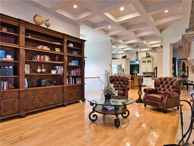 living area with beam ceiling, coffered ceiling, and light wood-type flooring