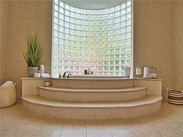 bathroom with tile patterned floors and tile walls