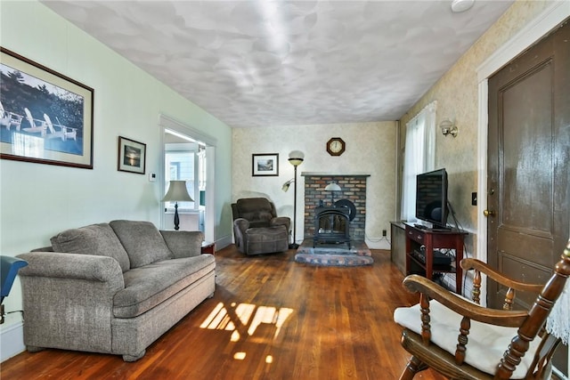 living room featuring dark hardwood / wood-style floors and a wood stove