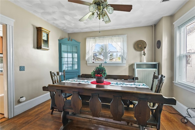 dining area with dark hardwood / wood-style floors, a wealth of natural light, and ceiling fan