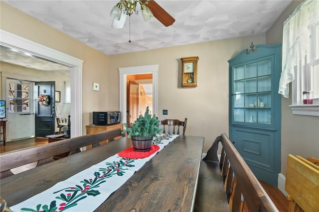 dining room featuring ceiling fan and hardwood / wood-style flooring