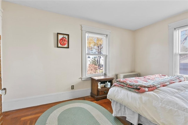 bedroom with dark wood-type flooring