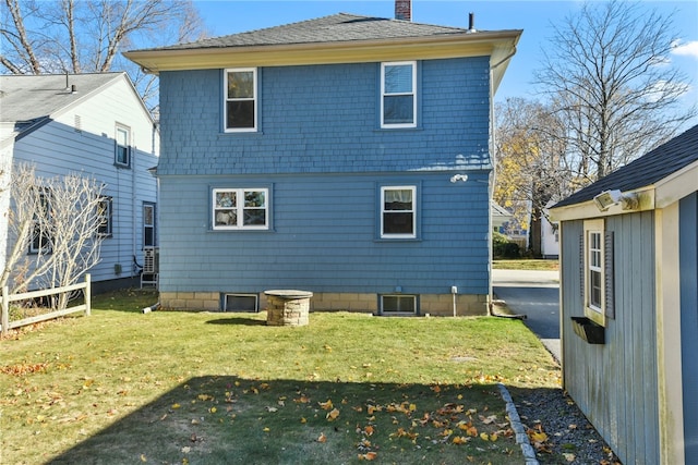 back of house featuring a yard