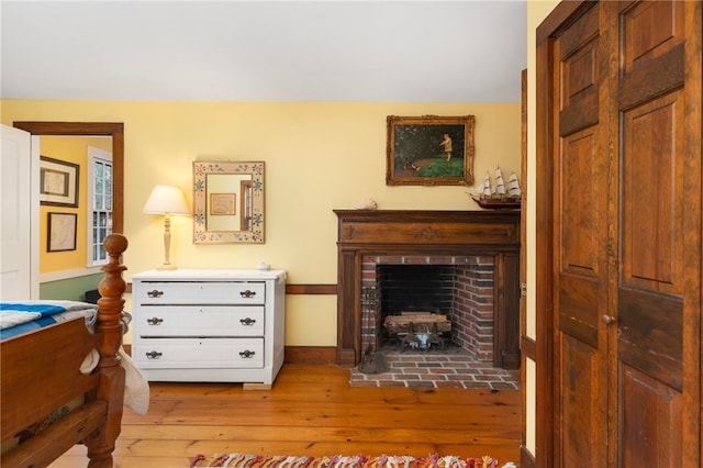 living area with a fireplace and light hardwood / wood-style flooring