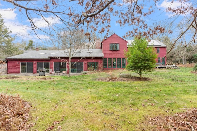 rear view of property with a yard