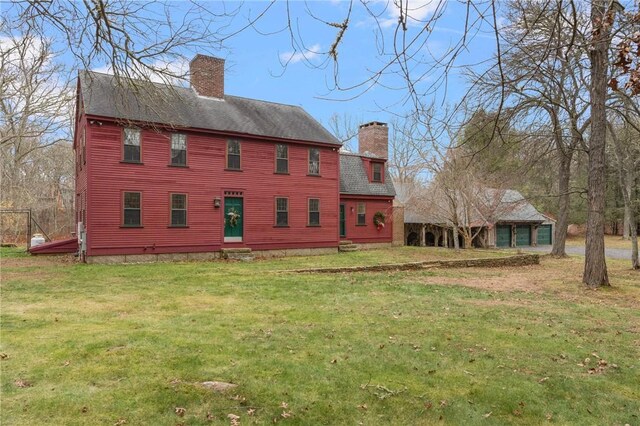 rear view of house with a lawn