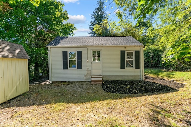 view of outbuilding featuring a lawn