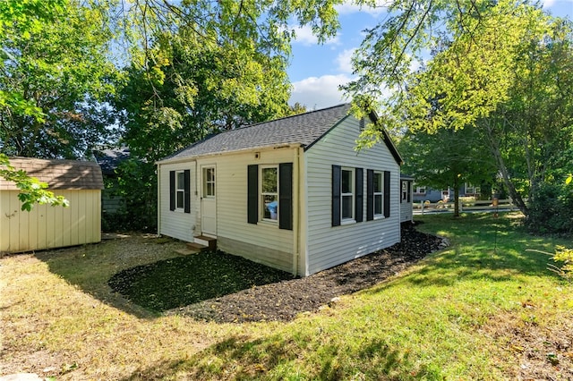 view of outbuilding with a yard