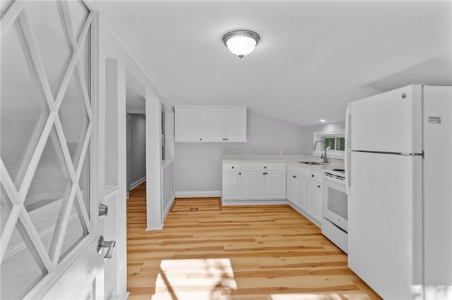 kitchen with sink, white cabinets, white appliances, and light wood-type flooring