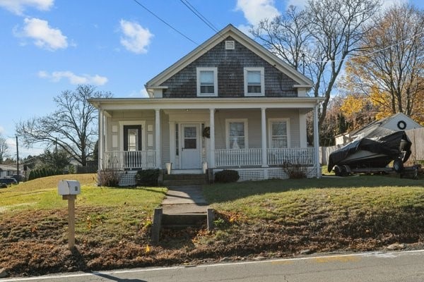 bungalow featuring a front yard and a porch