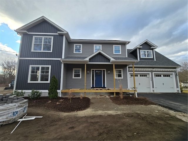 view of front of property with covered porch and a garage