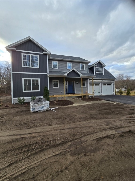 view of front of property with a porch and a garage