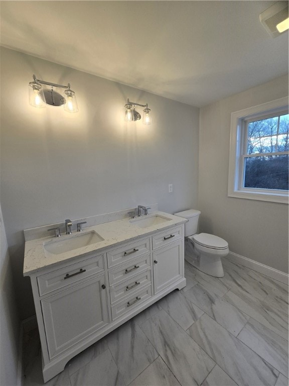 bathroom featuring vanity and toilet