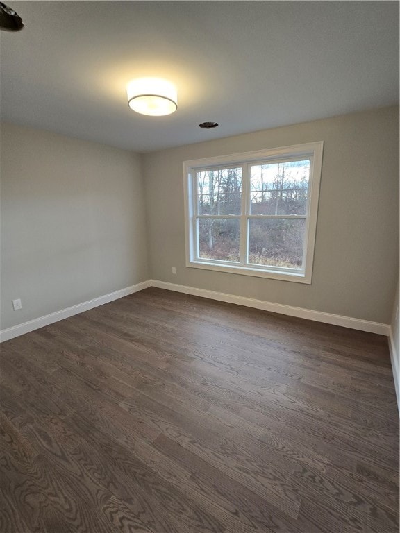 unfurnished room featuring dark hardwood / wood-style floors