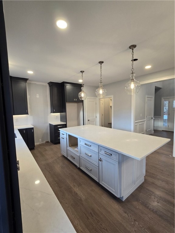 kitchen featuring pendant lighting, a center island, and dark wood-type flooring