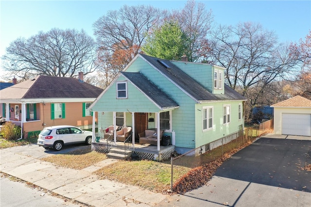 view of front facade featuring a porch, a garage, and an outdoor structure