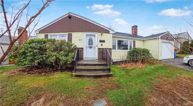 view of front facade with a front yard and a garage