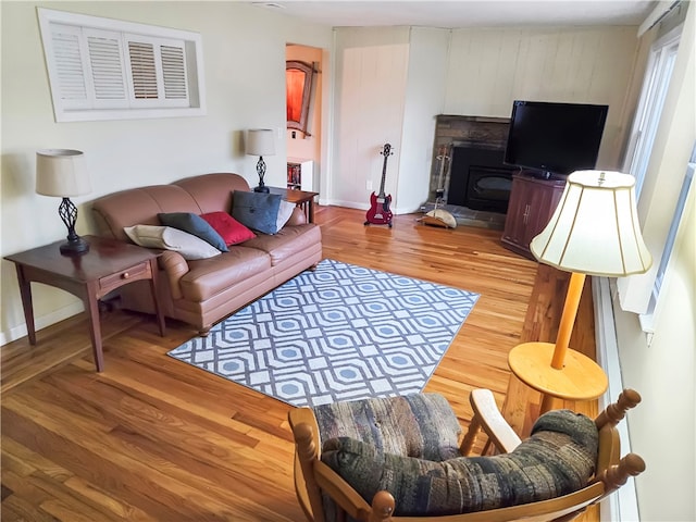 living room featuring a fireplace and light hardwood / wood-style flooring