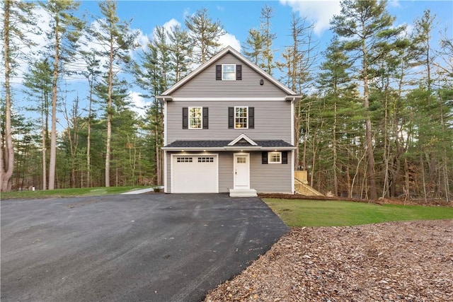 front facade featuring a front lawn and a garage