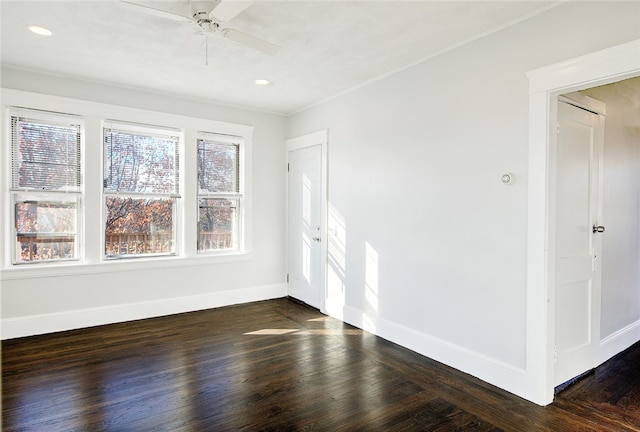 empty room featuring ceiling fan and dark hardwood / wood-style floors