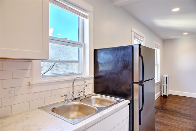 kitchen featuring stainless steel fridge, a healthy amount of sunlight, and sink