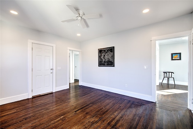 spare room featuring ceiling fan and dark hardwood / wood-style flooring