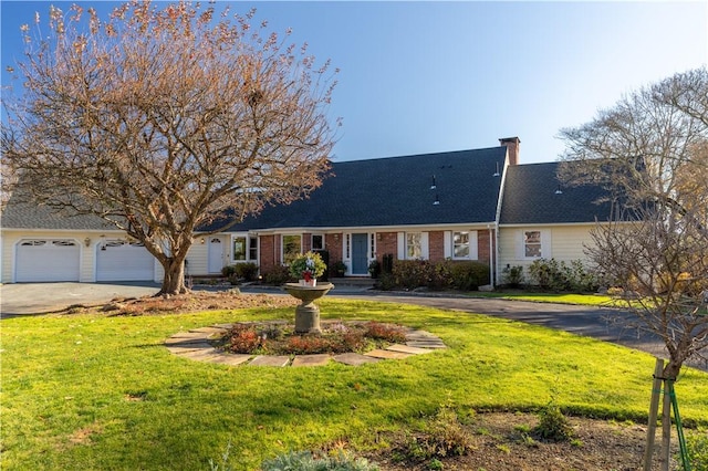 ranch-style house featuring a garage and a front lawn