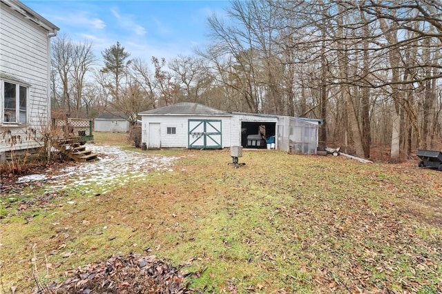 view of yard with a wooden deck and an outdoor structure