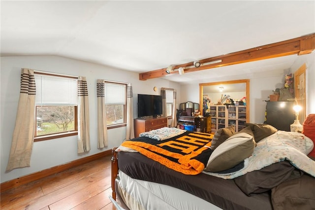 bedroom featuring light hardwood / wood-style floors and vaulted ceiling