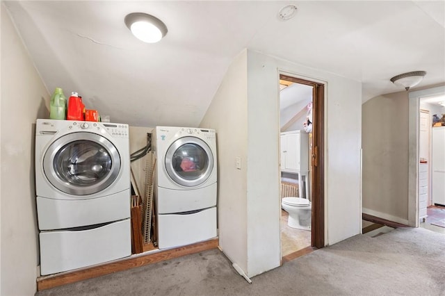 washroom with washer and dryer and light colored carpet