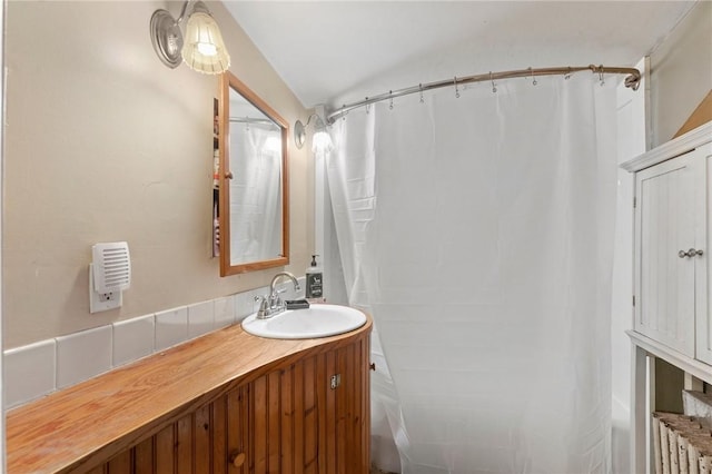 bathroom with vanity and lofted ceiling