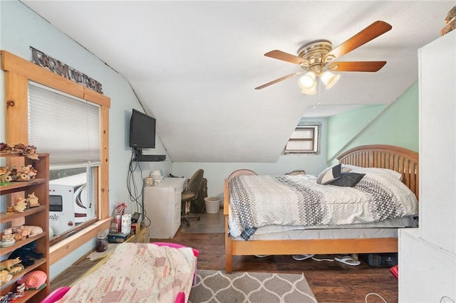 bedroom with lofted ceiling, ceiling fan, and dark wood-type flooring