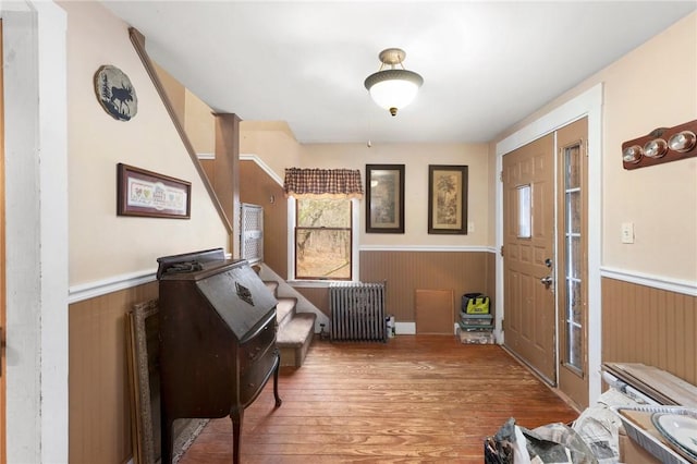 foyer entrance featuring hardwood / wood-style floors and radiator