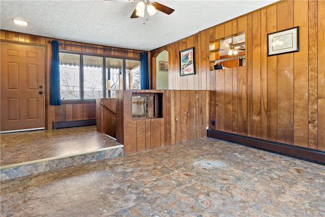 entrance foyer with wood walls and a baseboard radiator